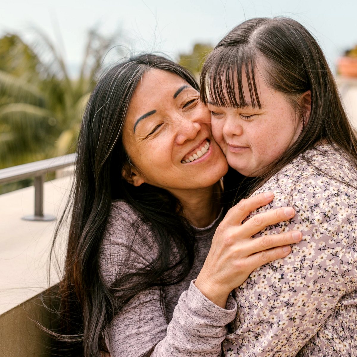 Support worker hugging an adult with a learning disability